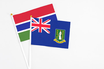 Fototapeta premium British Virgin Islands and Georgia stick flags on white background. High quality fabric, miniature national flag. Peaceful global concept.White floor for copy space.
