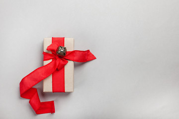 elongated gift box with a red ribbon on a gray background. blank for postcard, poster, banner, place for your text