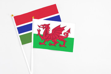 Wales and Georgia stick flags on white background. High quality fabric, miniature national flag. Peaceful global concept.White floor for copy space.
