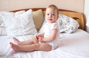 Portrait of a baby boy on the bed in bedroom 