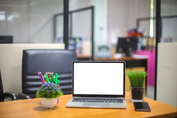 Computer laptop with white blank screen isolated  on work table in office.