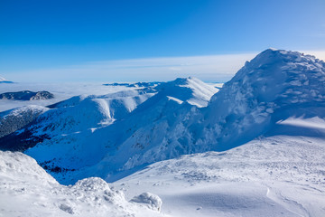 Fototapeta na wymiar Blue Sky over Snowy Peaks