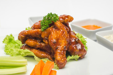 Barbecue chicken wings with vegetables and sauces