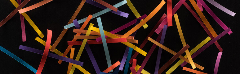 top view of multicolored abstract lines scattered isolated on black background, connection and...