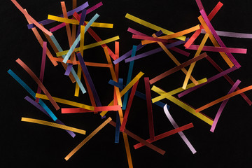 top view of multicolored abstract lines scattered isolated on black background, connection and communication concept