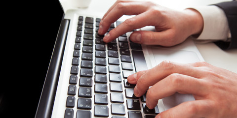 Fototapeta na wymiar Man hand on laptop keyboard