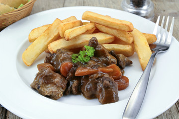 bourguignon beef and fries on a plate