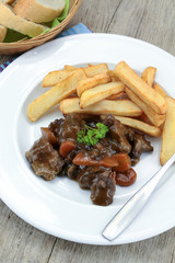 bourguignon beef and fries on a plate