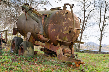 Fototapeta na wymiar Rusty tank. Front view of an old rusty tanker with pump mechanism.