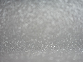 Abstract grey glitter bokeh lights, metallic sparkle. defocused.