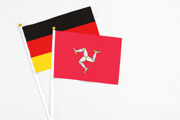 Isle Of Man and Germany stick flags on white background. High quality fabric, miniature national...