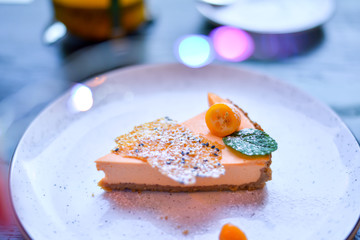cake on a plate in colorful lights