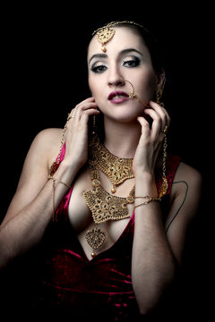 Beautiful portrait fashion model wearing indian jewelry posing on black background isolated, Mexico