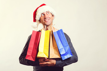 Happy man buying christmas gifts for family celebration. Winter shopping sales. Christmas holiday celebration. Happy new year