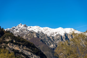 Snow capped mountains in the Giudicarie Alps seen from the Lake Tenno, Trento province,...