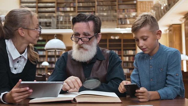 Respected 70-aged bearded man dissappointing because 12s grandchildren playing on modern devices rather then read exciting book