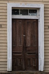 Obraz na płótnie Canvas An old, abandoned, vintage double front door. Shot in portrait, vertical orientation. Gordonsville, Virginia.