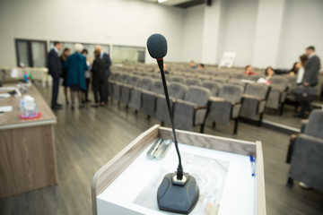 Wired microphone close up with copy space . Close up of microphone in concert hall or conference room . Wired microphone set up on the front of conference room close up with blurred background. - obrazy, fototapety, plakaty