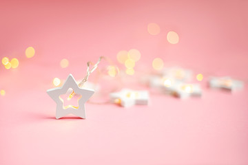 Merry Christmas and Happy Holidays  banner and greeting card. New Year. Wooden stars on a yellow christmas light bokeh background with copy space.Winter holiday theme.Wallpaper.