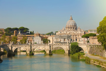 St. Peter Basilica over bridge and Tiber river in Rome, Italy.