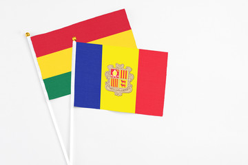 Andorra and Ghana stick flags on white background. High quality fabric, miniature national flag. Peaceful global concept.White floor for copy space.