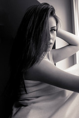 Naklejka premium sexy woman lying on bed at home close up