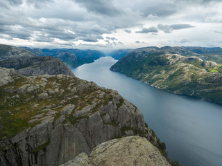 View on fjord Lysefjord, from Preikestolen massive cliff famous Norway viewpoint Moody sky, autumn day. Nature and travel background, vacation and hiking holiday concept.