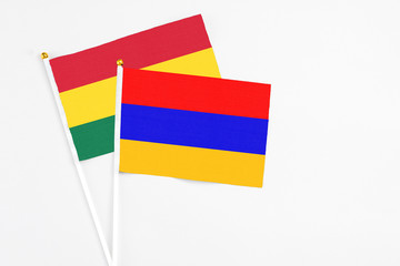 Armenia and Ghana stick flags on white background. High quality fabric, miniature national flag. Peaceful global concept.White floor for copy space.