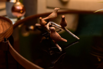 decorative wooden birds on the living room table © liligluck