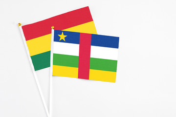 Central African Republic and Ghana stick flags on white background. High quality fabric, miniature national flag. Peaceful global concept.White floor for copy space.