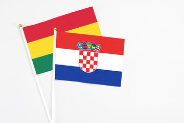 Croatia and Ghana stick flags on white background. High quality fabric, miniature national flag. Peaceful global concept.White floor for copy space.