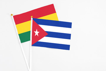 Cuba and Ghana stick flags on white background. High quality fabric, miniature national flag. Peaceful global concept.White floor for copy space.