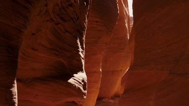 Movement In Deep Slot Canyon With Wavy And Smooth Sandstone Walls Bright Orange