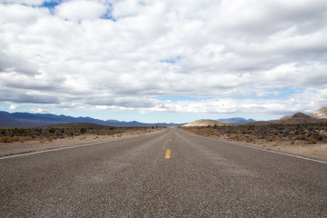 Highway in a cloudy day, countryside USA. Empty national road, passing through American desert.