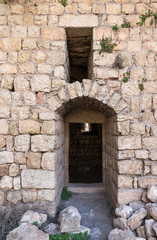 Fototapeta na wymiar Side exit from the main hall in ruins of crusader Fortress Chateau Neuf - Metsudat Hunin is located at the entrance to the Israeli Margaliot village in the Upper Galilee in northern Israel