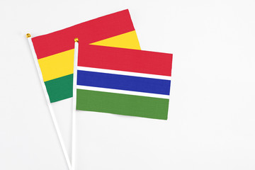 Gambia and Ghana stick flags on white background. High quality fabric, miniature national flag. Peaceful global concept.White floor for copy space.