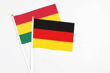Germany and Ghana stick flags on white background. High quality fabric, miniature national flag. Peaceful global concept.White floor for copy space.