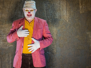 Crazy aggressive clown with red ball and shadow. man hates his work and in his free time dresses...