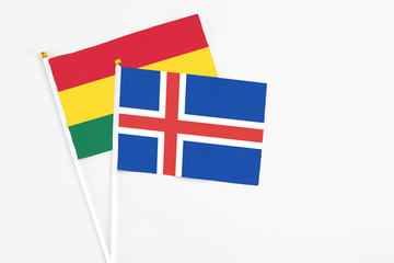Obraz premium Iceland and Ghana stick flags on white background. High quality fabric, miniature national flag. Peaceful global concept.White floor for copy space.