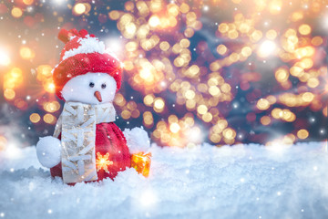 Christmas background with a cute toy snowman