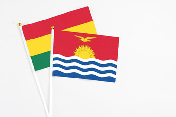 Kiribati and Ghana stick flags on white background. High quality fabric, miniature national flag. Peaceful global concept.White floor for copy space.