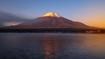 Fototapeta na wymiar Sunrise landscape of Fuji Mountain with fog in the morning at Yamanaka Lake, Yamanashi, Japan