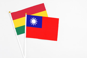 Taiwan and Ghana stick flags on white background. High quality fabric, miniature national flag. Peaceful global concept.White floor for copy space.