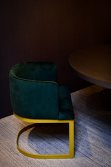 black table and green chair, inner decoration, modern furniture, contemporary furniture, emerald green velvet accent chair, modern design furniture detail, luxurious contemporary interior