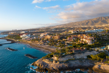 Aerial drone shot of Costa Adeje, South Tenerife, Spain. Beautiful golden hour landscape. Premuim beaches and luxury hotels area. © footagelab