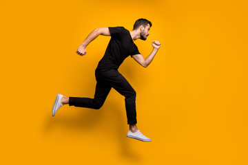 Full length profile photo of handsome millennial guy jumping high rushing low prices discount...