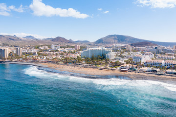 Aerial drone view of Playa de las Americas area, Tenerife, Spain. Amazing ocean landscape with lots...