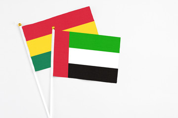 United Arab Emirates and Ghana stick flags on white background. High quality fabric, miniature national flag. Peaceful global concept.White floor for copy space.