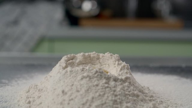 Chef throws raw egg to the flour on slow motion, egg yolk falls in 240fps, making the dough, cooking at the kitchen, home pastry, Full HD Prores 422 HQ 240 fps 10 bit