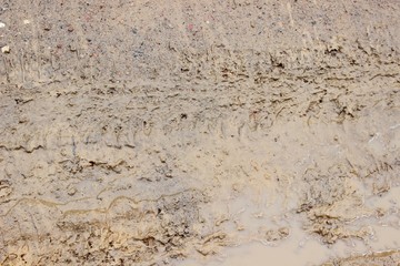Car wheel protector on yellow dirty sand
